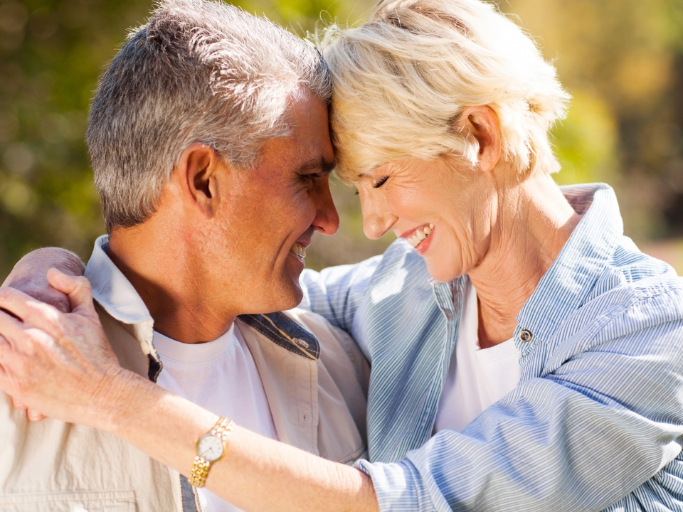 Mature couple embracing happily outdoors